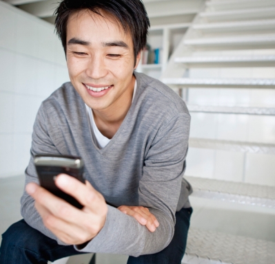 Man sitting on stairs using cell phone